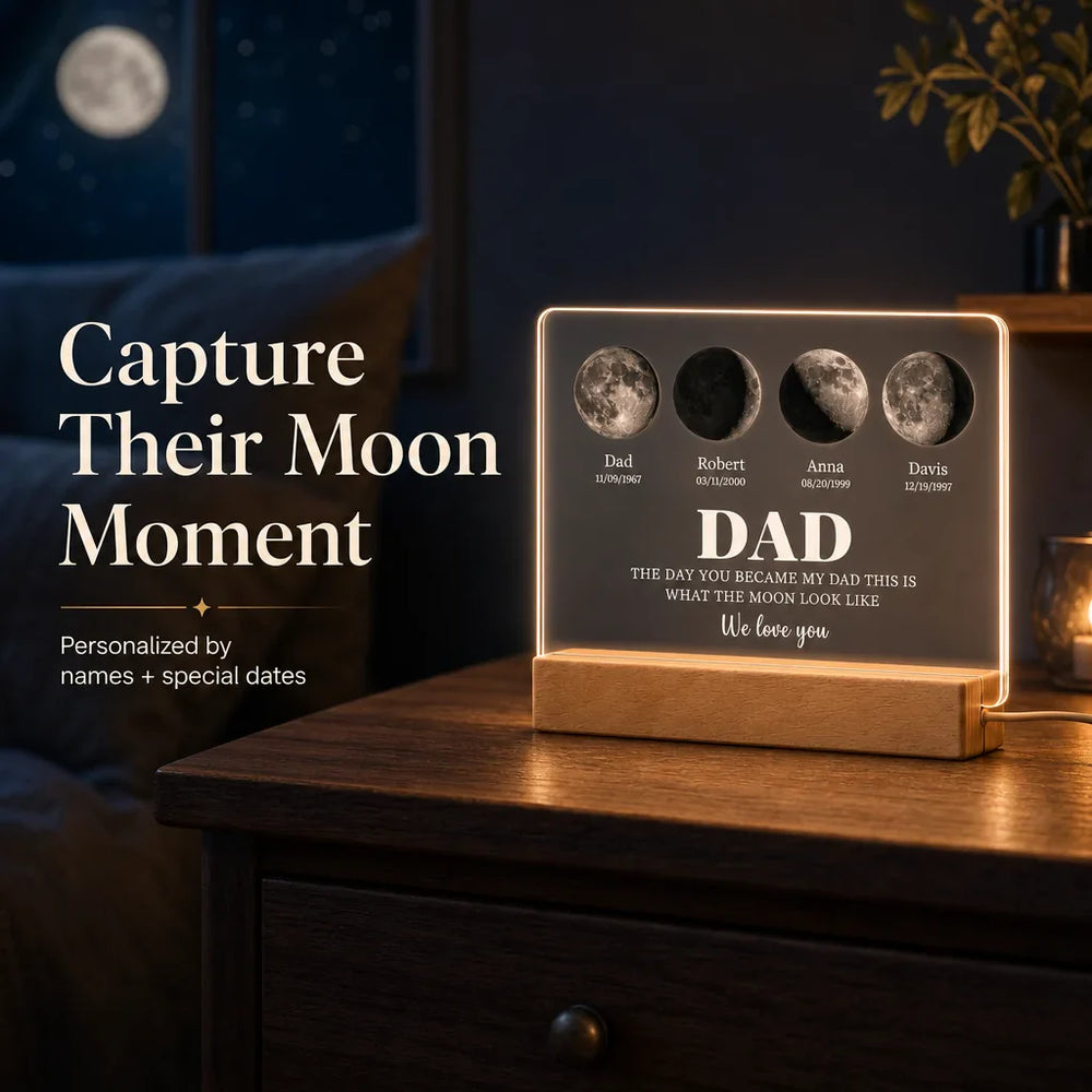 Moon phase keepsake plaque glowing on a bedroom dresser at night, four lunar phases and family names lit by warm LED from below, soft moon illustration on wall behind.