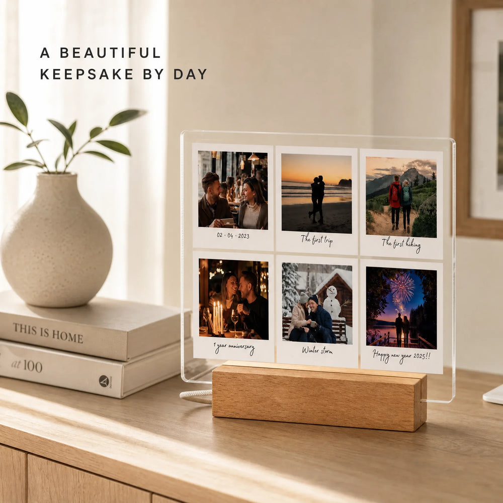 Polaroid photo plaque on a wooden console in daylight, six Polaroid frames with captions on clear acrylic next to a vase and books.